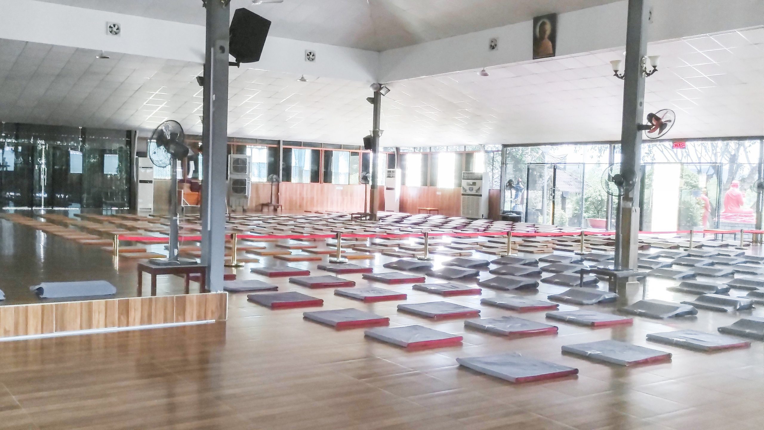 The main meditation hall (phòng thiền) with rows of cushions and mosquito nets at Pháp Đăng Thiền Tuệ